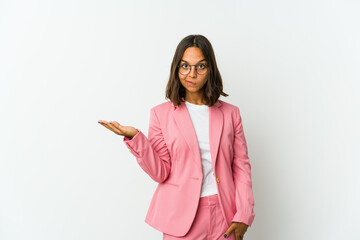 Young latin business woman isolated on white background holding a copy space on a palm.