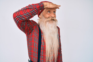 Old senior man with grey hair and long beard wearing hipster look with wool cap very happy and...