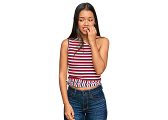 Fototapeta premium Beautiful hispanic woman wearing casual clothes looking stressed and nervous with hands on mouth biting nails. anxiety problem.
