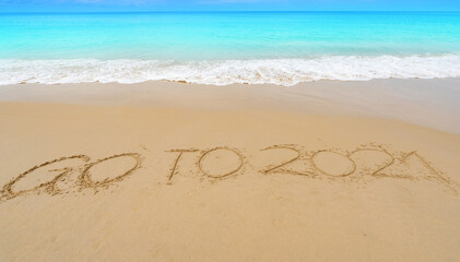 Happy New Year 2021 lettering Text on the beach with wave and white sea foam ,writing Go to 2021 Text on the seashore wave crashing on sandy shore Concept happy new year and new idea design background