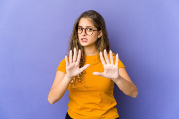 Young caucasian cute woman rejecting someone showing a gesture of disgust.