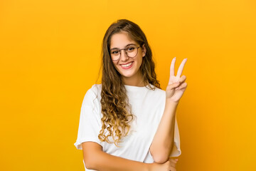 Young caucasian woman showing number two with fingers.