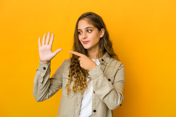 Young caucasian woman smiling cheerful showing number five with fingers.