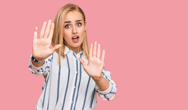 Beautiful caucasian woman wearing casual clothes doing stop gesture with hands palms, angry and frustration expression