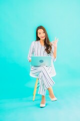 Portrait beautiful young asian woman use computer laptop and sit on chair