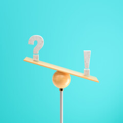 wooden scale balancing a question mark and an exclamation mark tipping more the right side on colorful background
