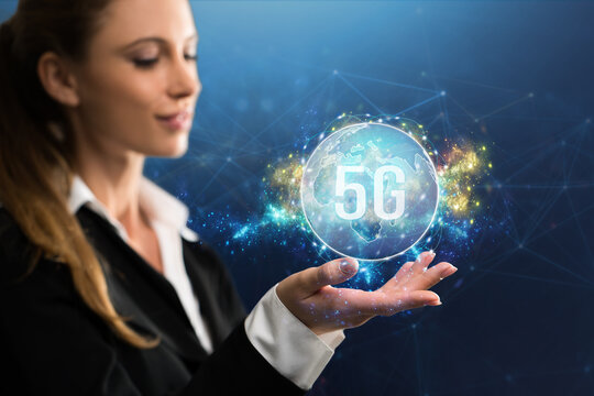 businesswoman presenting a virtual world map with message 5G in front of an abstract blue background
