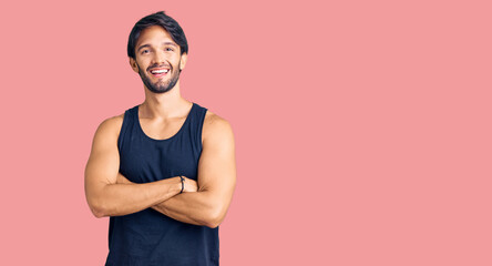 Handsome hispanic man wearing casual clothes happy face smiling with crossed arms looking at the camera. positive person.