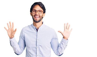 Handsome hispanic man wearing business shirt and glasses showing and pointing up with fingers number ten while smiling confident and happy.