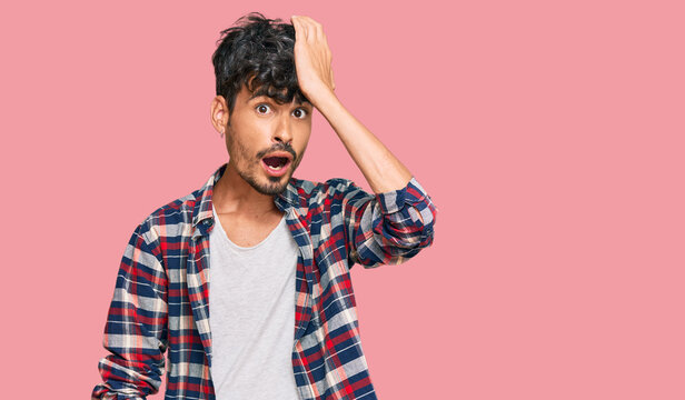 Young hispanic man wearing casual clothes surprised with hand on head for mistake, remember error. forgot, bad memory concept.