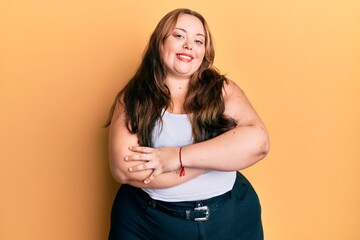 Obraz premium Plus size caucasian young woman wearing casual clothes happy face smiling with crossed arms looking at the camera. positive person.