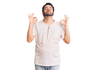 Young hispanic man wearing casual clothes relax and smiling with eyes closed doing meditation gesture with fingers. yoga concept.