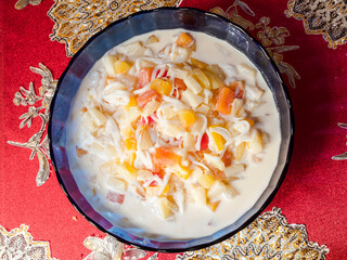 Top view of Buko Salad, a Filipino fruit salad dessert made from strips of fresh young coconut with...