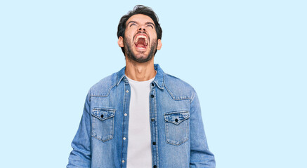 Young hispanic man wearing casual clothes angry and mad screaming frustrated and furious, shouting with anger. rage and aggressive concept.