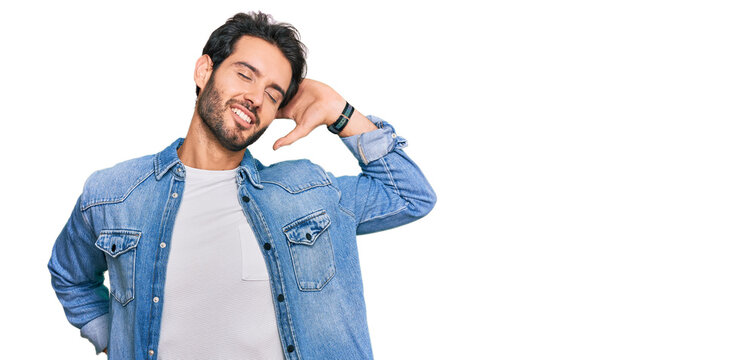 Young hispanic man wearing casual clothes stretching back, tired and relaxed, sleepy and yawning for early morning