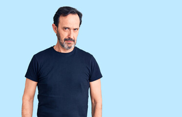 Fototapeta premium Middle age handsome man wearing casual t-shirt skeptic and nervous, frowning upset because of problem. negative person.