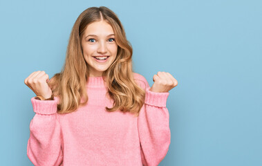 Fototapeta premium Beautiful young caucasian girl wearing casual winter sweater celebrating surprised and amazed for success with arms raised and open eyes. winner concept.