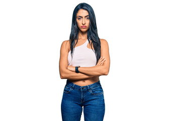 Beautiful hispanic woman wearing casual clothes skeptic and nervous, disapproving expression on face with crossed arms. negative person.