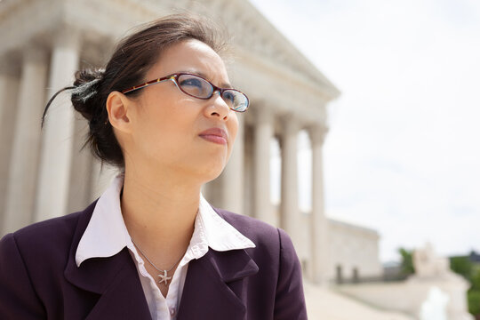 Beautiful Mid Adult Asian American Woman In Front Of The U.S. Supreme Court Building In Washington, DC