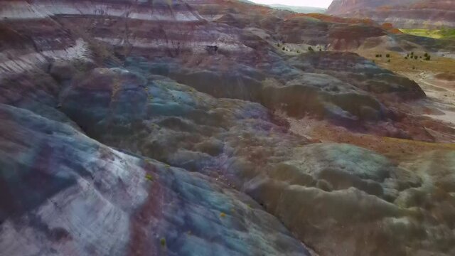 Cinematic aerial flyover of colorful sandstone strata at sunset in Southern  Utah