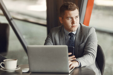 Businessman. Guy in a suit. Male use a laptop.