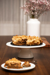Delicious coffee cake with buttercream icing and walnuts.