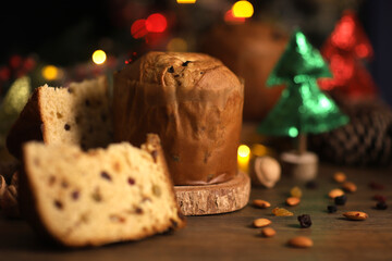 Delicious slice of Panettone with candied fruit on the table on a blurred background