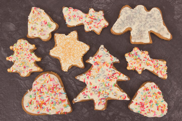 Fresh baked gingerbread in shape of christmas tree, heart and star with colorful decorations for Christmas time