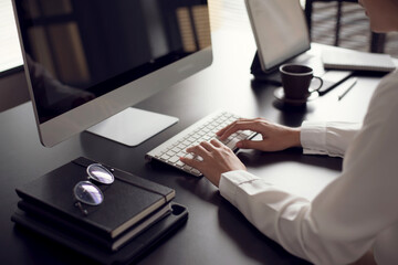 Close up. Businesswoman working on laptop computer keyboard in office.