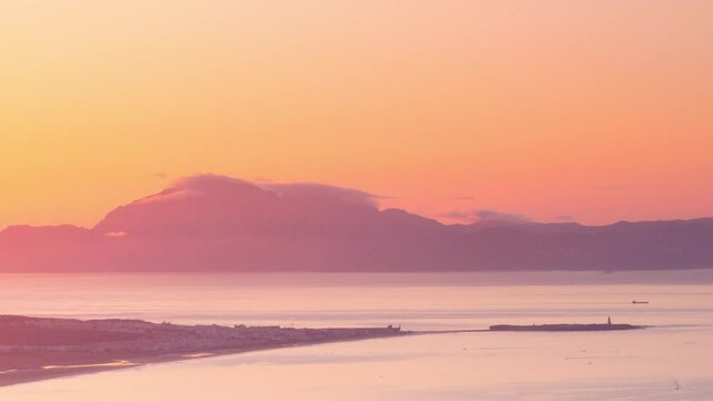 Close up view Sunrise timelapse strait of Gibraltar in a summer morning. Boats and cargo boats passing by. Tarifa view
