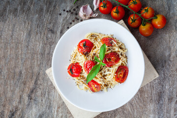 Pasta, spaghetti with tomato sauce in white bowl on old wood background. Copy space.