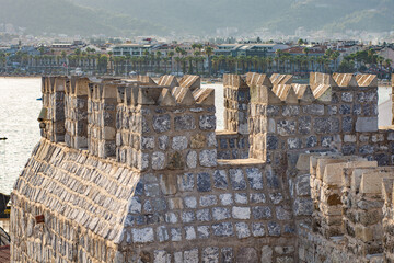 part of the medieval Fort. the walls and towers are made of large rough stone blocks. historic, heritage background © Celt Studio
