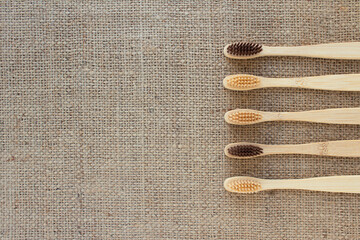 Mockup image of natural bamboo toothbrushes on rustic background with copy space. Sustainable...