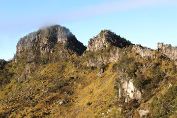 beautiful rock hill on top volcanic mountain in central java indonesian, wildlife nature landscape sunny weather with blue sky background wallpaper photo