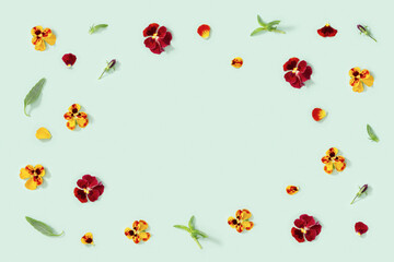 Modern floral frame with yellow and red pansy flowers, small summer flat lay flowery seasonal styling