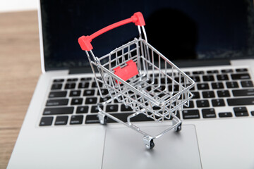 An empty shopping cart model on a laptop keyboard