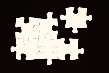white puzzles on a black background. business concept