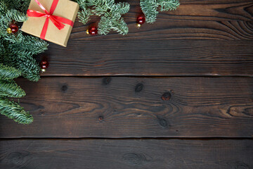 Christmas decoration, frame concept background, top view on natural rustic wood table surface. Fir tree branches border and christmas decoration with copy space
