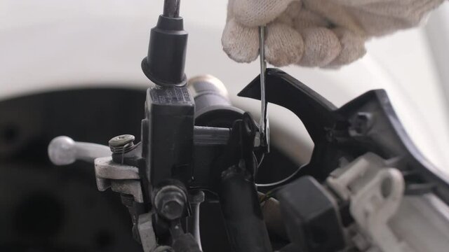 Close up shot mechanic hands using fix wrench to repair the car