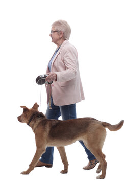 Side View . Senior Lady And Her Dog Walking Together