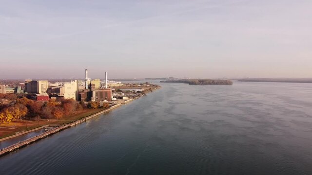 Flying Towards Shut Down Power Plant Station Of Wyandotte Michigan City At Detroit River During Fall Season. - Drone Shot