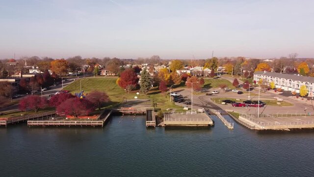 The Trenton City With Colorful Autumn Landscape Along Detroit River In Michigan, USA - Aerial Sideways