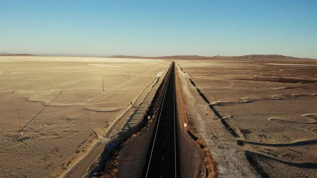 Highway 50, The Loneliest Road in America, as it passes through Salt Wells Nevada at Sunrise.  Aerial Drone Clip