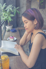 Young woman enjoy day with book, cake and tea