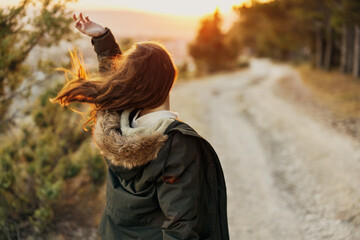 Nature fresh air travel woman in jacket back view