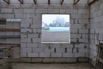 Construction concept. Photo of a window, an empty opening in an unfinished house.