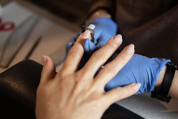 Closeup shot of a woman in a nail salon receiving a manicure - obrazy, fototapety, plakaty