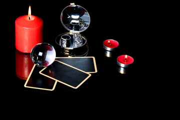 Magical sessions with tarot cards, candle and mirror at night in dark room. Mysterious fortune telling. Magic ritual. Mystical atmosphere. Copyspace