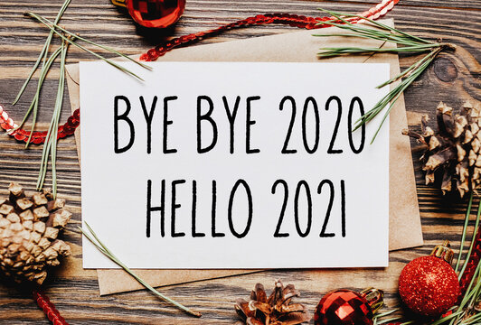 Merry christmas and merry new year concept with gift boxes, toys and notebook with text Bye bye 2020 Hello 2021