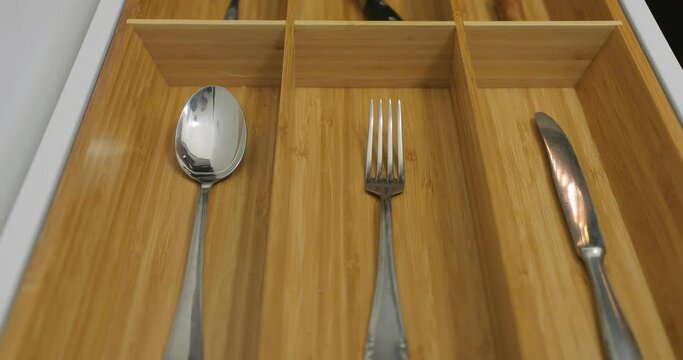 One piece of types of cutlery in the drawer of the kitchen cabined as a minimalist organizing system